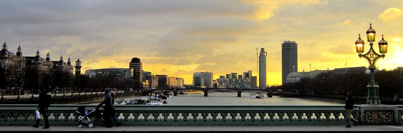 Buildings in city at sunset