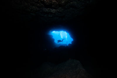 Man in blue light at night