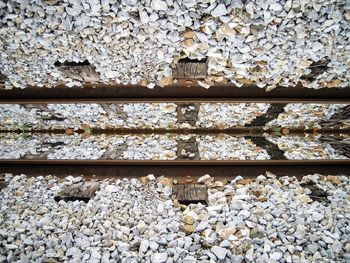 High angle view of railroad track and gravels on field