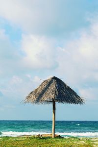 Lifeguard hut on beach against sky