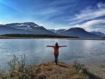 Woman standing on lakeshore