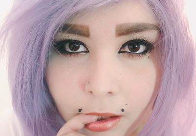 Close-up portrait of beautiful woman against white background