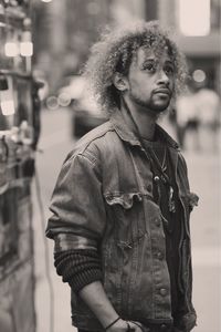 Thoughtful man standing in city