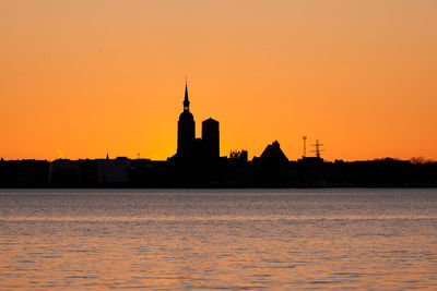 Scenic view of sea against clear sky during sunset