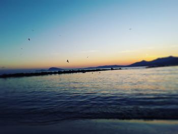 Scenic view of sea against sky at sunset