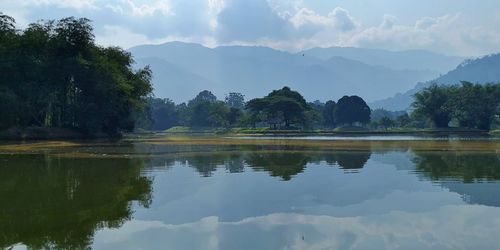 Scenic view of lake and mountains against sky