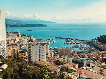 High angle view of buildings and sea against sky