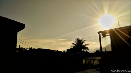 High section of silhouette houses at sunset