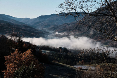 Scenic view of land and mountains against sky