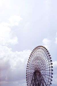 Low angle view of ferris wheel against sky