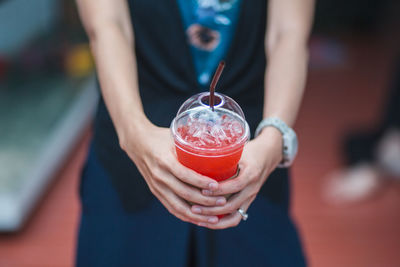 Close-up of woman holding drink