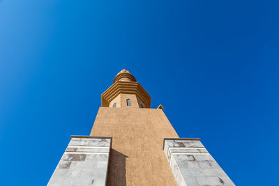 Low angle view of building against clear blue sky