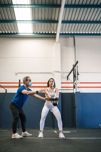 Full length of woman with arms raised