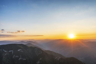 Scenic view of mountains against sky during sunset