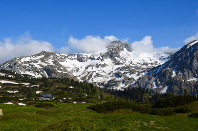 Scenic view of mountains against blue sky