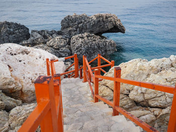 High angle view of rocks by sea against sky