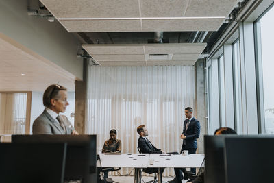 Business colleagues discussing strategy at corporate office