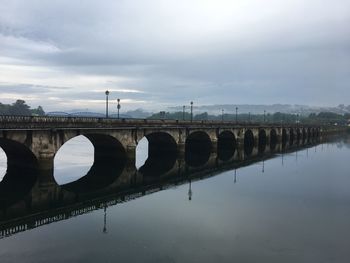 Ancient bridge reflection over the bay in spain