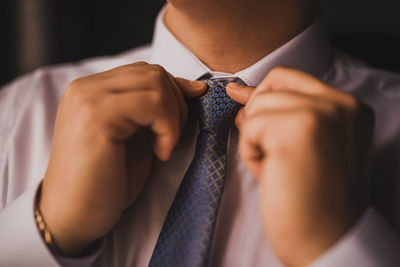 Midsection of man wearing suit