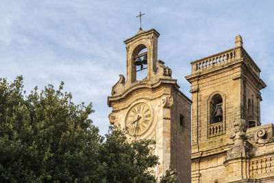 Low angle view of clock tower against sky