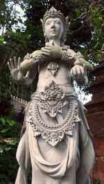 Low angle view of statue against trees