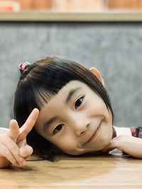 High angle view of cute girl sitting on table