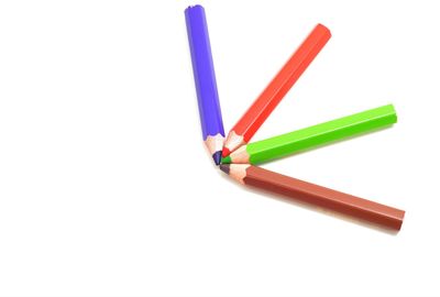 Close-up of colored pencils against white background