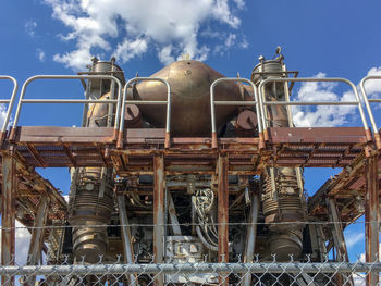 Low angle view of industry against sky