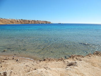 Scenic view of sea against clear blue sky