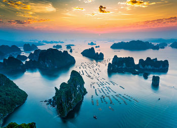 Aerial view of sea against sky during sunset