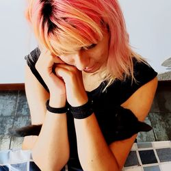 Portrait of beautiful woman sitting on floor