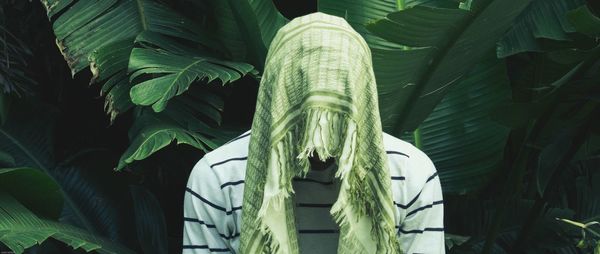 Panoramic view of man covering face with scarf