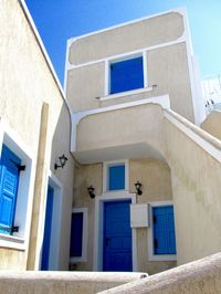 Low angle view of building against clear blue sky