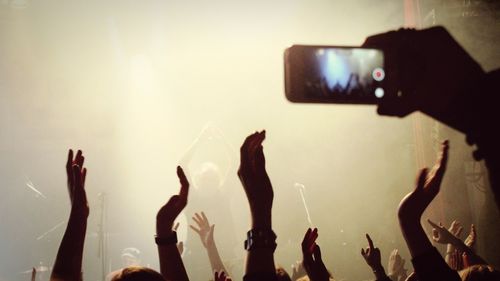 People photographing at music concert