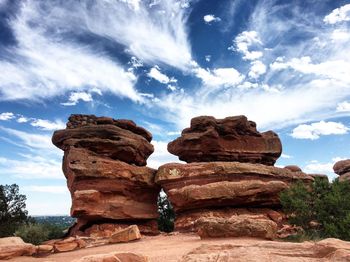 Rock formation on field against sky