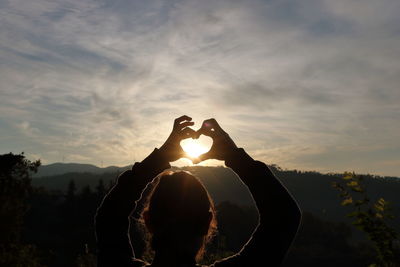 Silhouette man against sun during sunset