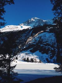 Scenic view of mountain range against cloudy sky