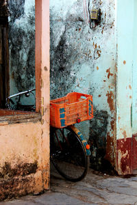 Crate on bicycle against wall