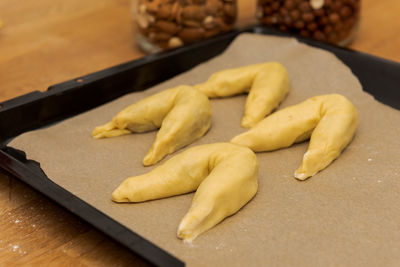 High angle view of bread in container on cutting board