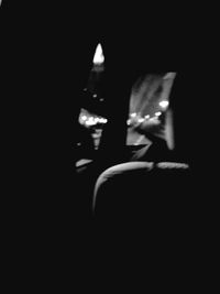Midsection of person in illuminated dark room