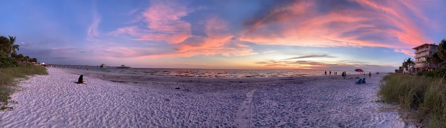 Panoramic view of beach against sky during sunset