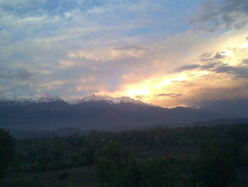 Scenic view of mountains against sky at sunset