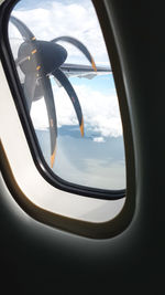 Close-up of airplane wing against sky