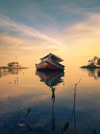 Scenic view of lake against sky during sunset