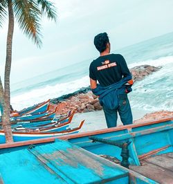 Man standing on beach against sky