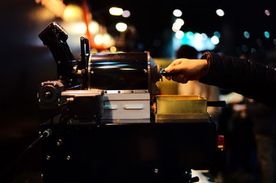 Close-up of man working at dusk