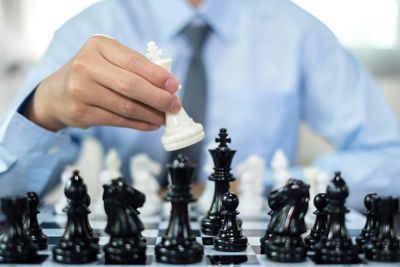 Midsection of man playing chess
