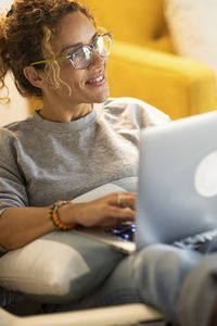 Portrait of woman using laptop at home