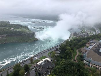 High angle view of sea by trees against sky