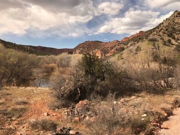 Scenic view of land and mountains against sky